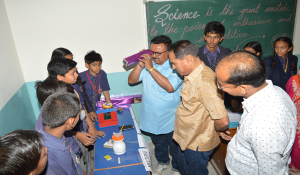 guests inspecting models in rooprajat school in sirohi.