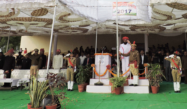 miniter devasi saluting tricolour by left hand and all officer and cadetes around him saluting by right hand in republic day functon in sirohi